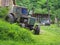 Old abandoned tractor stands on the deserted rural farmstead