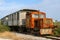 Old and abandoned train consisting of locomotive and old wooden wagons.