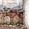 Old abandoned wall with bricked up windows