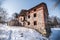 Old abandoned watermill exterior in winter