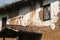 Old abandoned weathered rural house facade