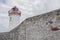 Old abandoned white light house. Cloudy sky