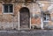 Old abandoned wooden door and windows weathered with age.