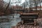 Old and abandoned wooden piano by the coast of the Vilnia river near Uzupis with the Bernardinu Bridge in the background in