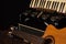 Old accordion and a beautiful guitar composing a scene on a rustic wooden surface with black background and low key lighting,