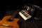 Old accordion and a beautiful guitar composing a scene on a rustic wooden surface with black background and low key lighting,