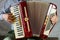 An old accordion is fun to play in the hands of an elderly musician