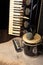 Old accordion, harmonica, bong and microphone on a rustic wooden surface with black background and low key lighting, selective