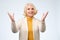 Old adult blonde excited cheerful astonished lady smiling, laughing