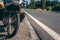 The old adventure motorcycle on the side of the road. The concept of a long trip on a tourist bike. asphalt road, place for text