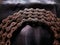 Old, aged, broken, and weathered motorbike chain on black fabric background