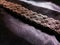 Old, aged, broken, and weathered motorbike chain on black fabric background