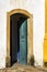 Old and aged historic church door in blue-green wood in the city of Ouro Preto