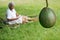 Old aged Pacific islander woman looks at avocado fruit grow in h