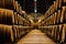 Old aged traditional wooden barrels with wine in a vault lined up in cool and dark cellar in Italy, Porto, Portugal, France