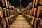 Old aged traditional wooden barrels with wine in a vault lined up in cool and dark cellar in Italy, Porto, Portugal, France