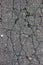 Old aged weathered cracked tarmac texture, large detailed damaged textured asphalt grungy background, vertical grey, black pattern