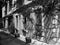 Old alley with floral decorations and a beautiful old building in the sunshine in Alacati, Turkey