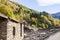 Old alpine village built on top of a mountain. Bell towers,Houses and stone roofs