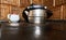 The old aluminum kettle on the stove. Tea pot.