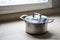 Old aluminum stainless steel cooking pot on kitchen table