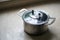 Old aluminum stainless steel cooking pot on kitchen table