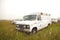 Old american ambulance van Ford Econoline at siberian fields
