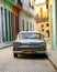 Old american car parked in Havana street