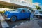 Old american car picking up a passenger in Havana