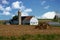 Old Amish White Wooden Barn and Farm Equipment