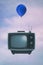 An old analogue television and a balloon in the sky