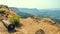 An old ancient Canon lying on the ground with a scenic view of the mountain ranges of Western Sahyadri Ghats of India.