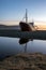 Old ancient, destroyed and abandoned norwegian whaling ship laying ashore in the westfjords of Iceland during sunset.