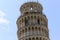 Old ancient leaning tower in the city of Pisa in Italy.