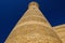 Old ancient minaret on the sky background.