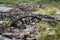 Old ancient packhorse bridge over mountain stream in Autumn