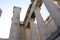 Old ancient restored Greek building with columns and roof in ancient Athens museum on a blue sunny sky