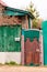 Old ancient wicket door with an old fence, the rustic house