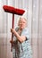 Old angry woman threatening with a broom