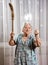 Old angry woman threatening with a broom