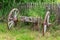 Old Animal Drawn Cart. Decorative old wheels from a rural cart. Old wooden cart inside a country garden