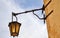 Old, antic, medieval and historic lantern hanging on a sand stone wall in Mdina, Malta