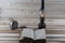 Old antique book opened with burning paraffin lamp near on the wooden table