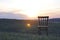 An old antique chair stands on the grass. At sunset. Summer. The concept of meditation and loneliness.