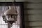 Old antique glass lamp hanging from the ceiling in rustic living room