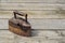 Old antique irons on vintage wooden background