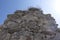 Old antique stone wall against blue sky