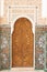 Old Arabian style gate entrance with a wooden closed door in Marrakesh landmark