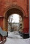 Old arch in  residential building with a crumbling facade in winter city historical quarter