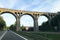 Old arched stone bridge over a road in Germany